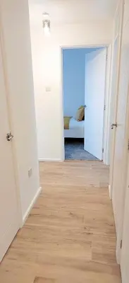 a hallway with a room with a bed in it at Modern 2 BR Apartment near Town in Newmarket