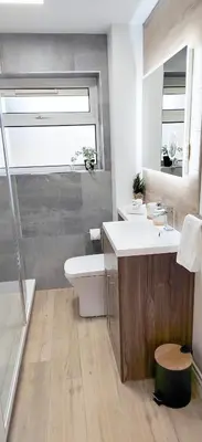 a bathroom with a sink and a toilet and a shower at Modern 2 BR Apartment near Town in Newmarket