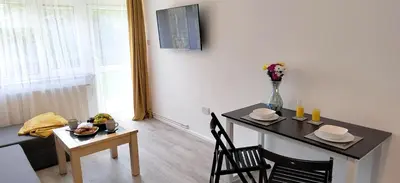 a living room with a table and a dining room at Modern 2 BR Apartment near Town in Newmarket