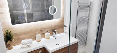 a bathroom with a white sink and a shower at Modern 2 BR Apartment near Town in Newmarket