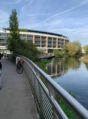 a building next to a bridge over a river at Bond Street Luxury Apartment Central Chelmsford in Chelmsford