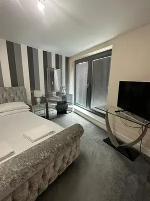 a bedroom with a bed and a flat screen tv at Bond Street Luxury Apartment Central Chelmsford in Chelmsford