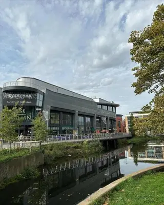 a building with a bridge over a river at Bond Street Luxury Apartment Central Chelmsford in Chelmsford
