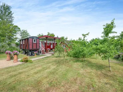 a train car sitting in a yard next to a house at Mahalia in Fordham