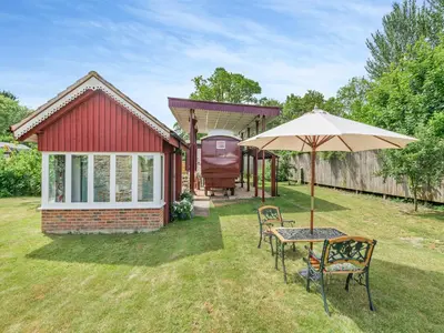 a garden with a table and chairs and an umbrella at Mahalia in Fordham