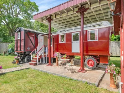 a red train car parked under a shed at Mahalia in Fordham