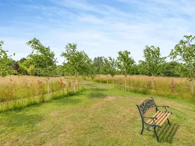 a park bench sitting in the middle of a field at Mahalia in Fordham