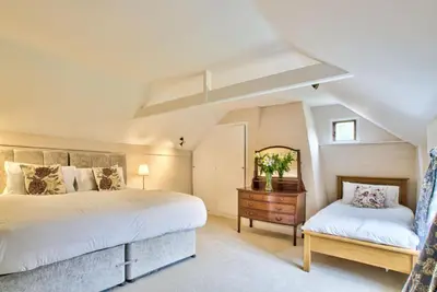 a bedroom with two beds and a mirror at Ashfield Place Farm by Group Retreats in Stowmarket