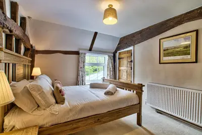 a bedroom with a bed and a window at Ashfield Place Farm by Group Retreats in Stowmarket