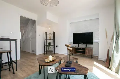 a living room with a tv and a table at Cozy House By AR Properties Short Lets & Serviced Accommodation Colchester in Colchester