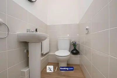 a bathroom with a toilet and a sink at Cozy House By AR Properties Short Lets & Serviced Accommodation Colchester in Colchester