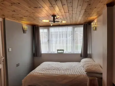a bedroom with a bed with a wooden ceiling at Mildenhall Suffolk in Mildenhall