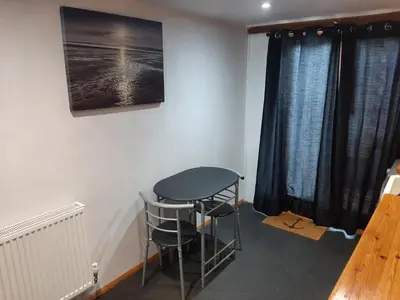 a room with a table and a stool in a room at Mildenhall Suffolk in Mildenhall