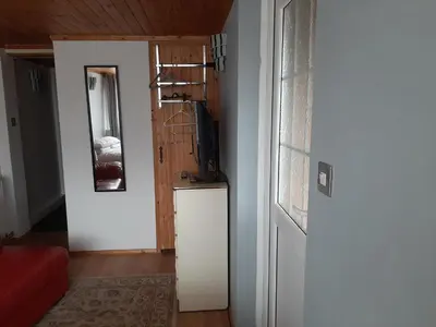 a living room with a door and a room with a refrigerator at Mildenhall Suffolk in Mildenhall