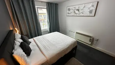 a small bedroom with a bed and a window at 2 Bedroom Flat Ground Floor Town Centre Colchester in Colchester