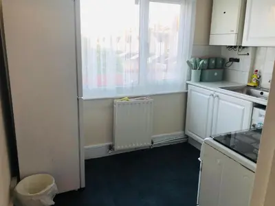 a kitchen with a window and a sink and a refrigerator at AC Lounge 119a in Rochford
