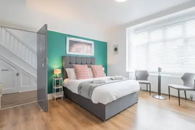 a bedroom with a bed and a green wall at The Modern Cambridge Studio 1 in Chesterton
