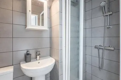 a bathroom with a toilet and a sink and a shower at The Modern Cambridge Studio 1 in Chesterton