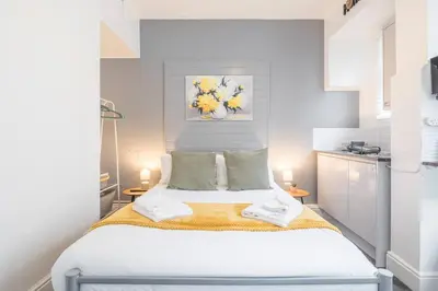 a bedroom with a large white bed in a room at The Modern Cambridge Studio 2 in Chesterton