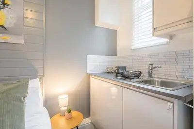 a small kitchen with a sink and a table at The Modern Cambridge Studio 2 in Chesterton