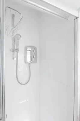 a shower in a bathroom with a mirror and a shower at The Modern Cambridge Studio 2 in Chesterton