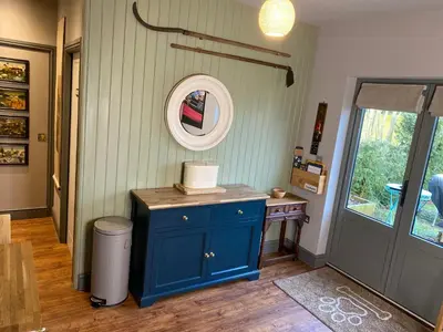 a room with a blue cabinet and a mirror at The BeeKeepers - Homely Luxurious Self Catering in Diss