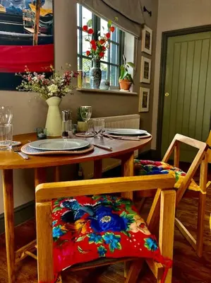a dining room table with a table and chairs with at The BeeKeepers - Homely Luxurious Self Catering in Diss