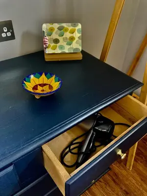 a blue table with a bowl and a box on it at The BeeKeepers - Homely Luxurious Self Catering in Diss