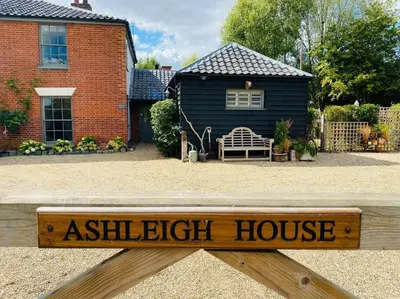 a wooden sign that reads ashleigh house in front of a house at The BeeKeepers - Homely Luxurious Self Catering in Diss
