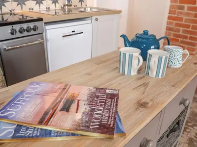 a book sitting on top of a kitchen counter at South Grange House - Sleep 16 in Saxmundham