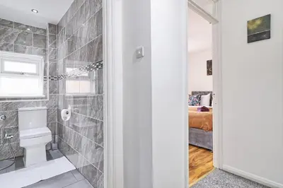 a bathroom with a toilet and a shower at Stylish 3 bedroom House In Grt Gregorie Basildon & Essex - Free Wifi, Parking, Dedicated Office & Private Garden in Basildon