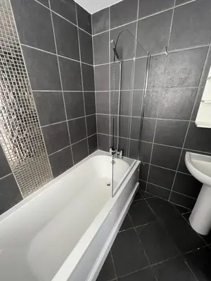 a bathroom with a tub and a toilet and a sink at 3 bed luxury open plan living in Rayleigh