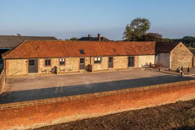an old brick building with a large parking lot at 1 Bed in Quidenham oc-2232 in Quidenham