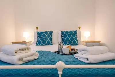 a bedroom with a bed with towels on it at 1 Abbey Mews, Leiston in Leiston