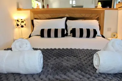 a bedroom with a bed with towels on it at The Little Barn in Hoxne