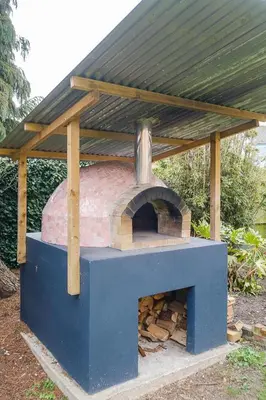 an outdoor oven with a roof on top of it at Frogmore Cottage in Leiston