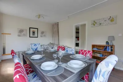 a dining room with a table with plates and glasses at The Red House Maldon in Maldon
