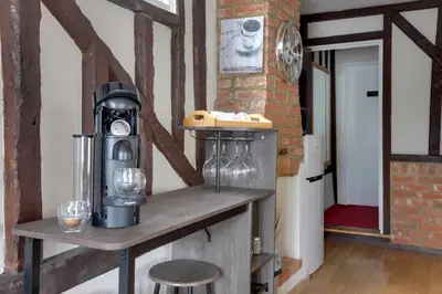 a room with a wooden table with glasses on it at The Red House Maldon in Maldon