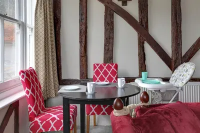 a living room with a table and two chairs at The Red House Maldon in Maldon