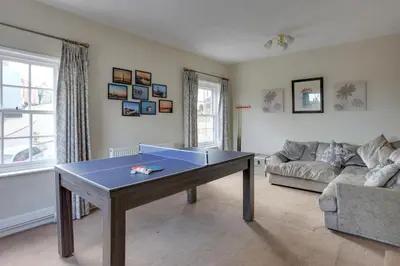 a living room with a table and a couch at The Red House Maldon in Maldon