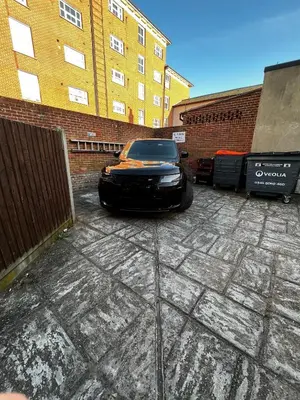 a black car parked in front of a brick building at Beach Front House in Walton-on-the-Naze