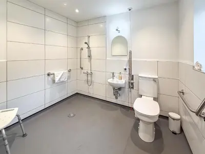 a bathroom with a toilet and a sink at Breckland Thatched Cottage in Hockwold cum Wilton