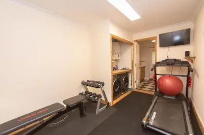 a room with a gym with a ball and a treadmill at The Forest House in Brandon