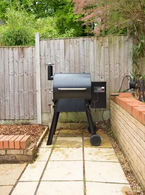 a bbq grill sitting next to a fence at The Forest House in Brandon