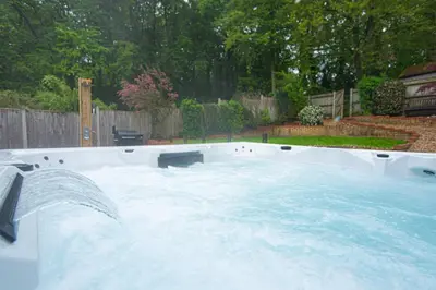 a large swimming pool in a backyard at The Forest House in Brandon
