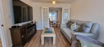 a living room with a couch and a table at The Forest House in Brandon