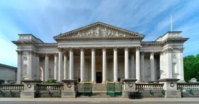 a large white building with columns on a street at Stylish Cambridge Home with free parking in Cambridge