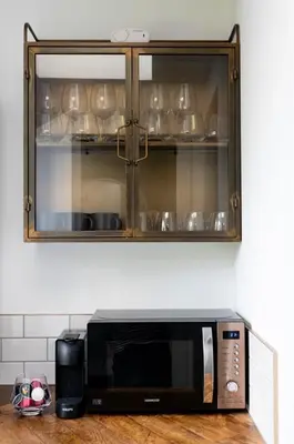a microwave sitting on a counter in a kitchen at Stylish Cambridge Home with free parking in Cambridge