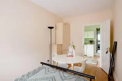 a room with a table and chairs and a kitchen at Fourwinds in Maldon