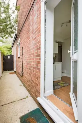 an open door of a brick building with a hallway at Fourwinds in Maldon